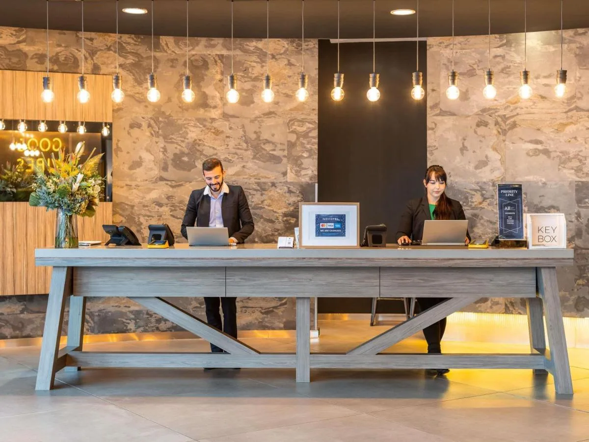 Guests working on laptops at a table in Novotel Edinburgh Centre on Lauriston Place