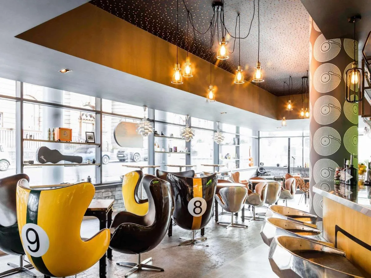 The Tap Kitchen & Bar with yellow and black chairs at Novotel Edinburgh Centre