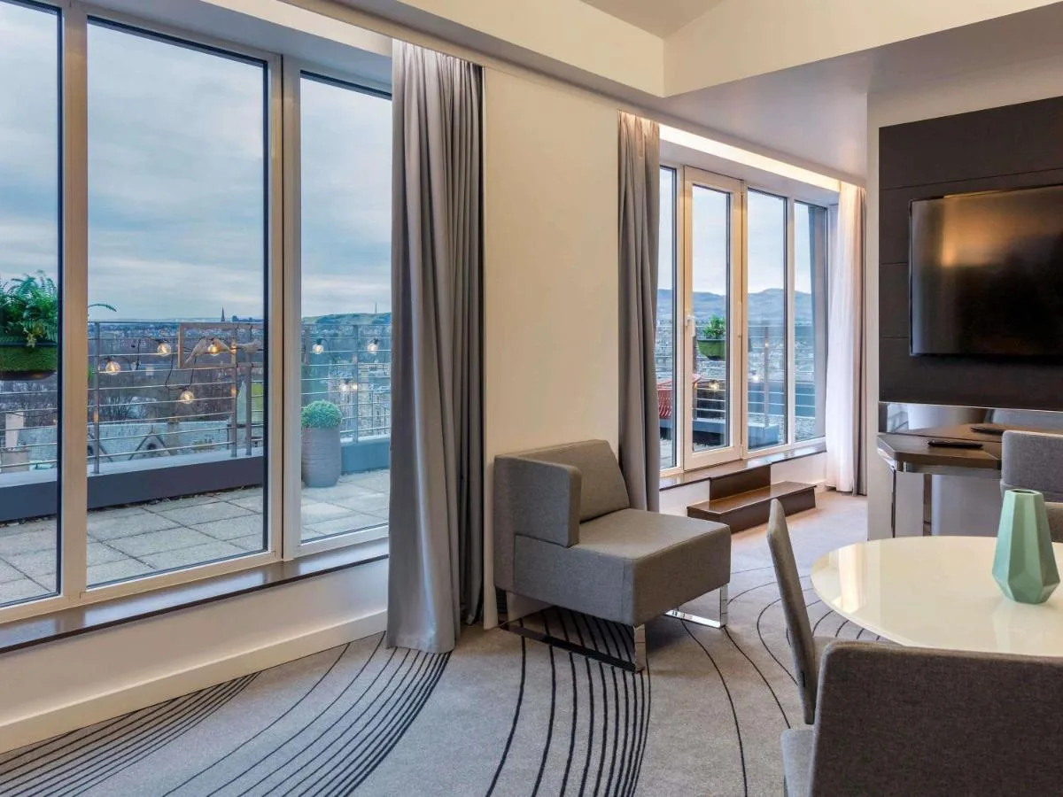 Bright lounge with a large window at Novotel Edinburgh Centre in Edinburgh's Old Town