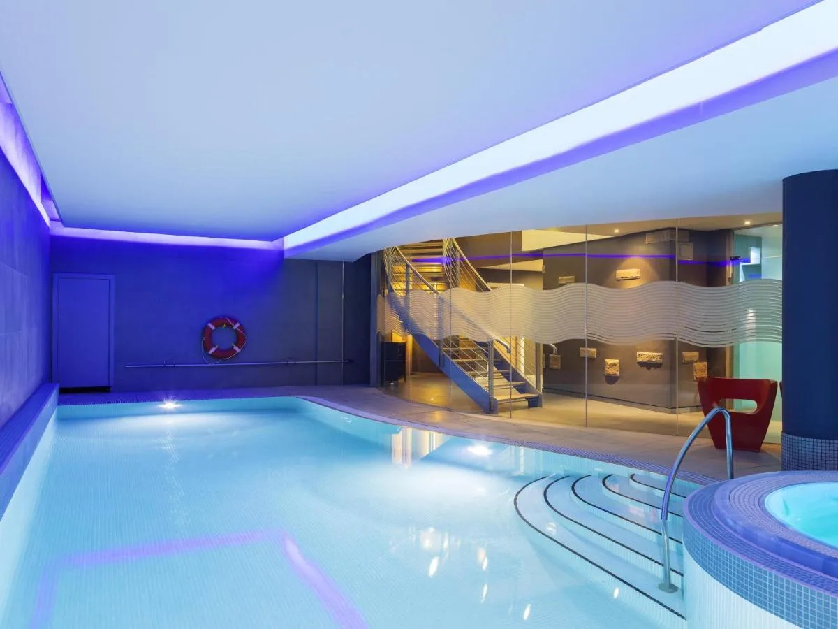 Indoor swimming pool with a slide at Novotel Edinburgh Centre